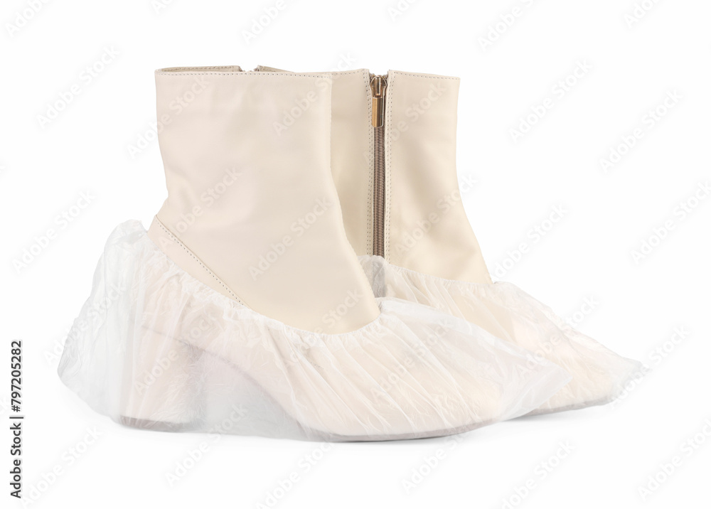 Women's boots in shoe covers isolated on white