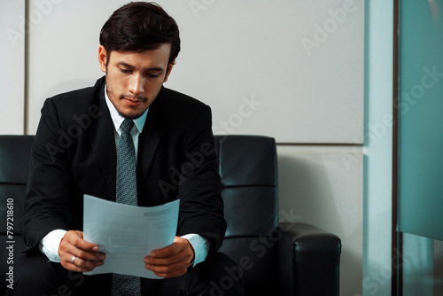 Stressed businessman candidate sit and wait for interview at the company office. Job application, business recruitment and Asian labor hiring concept. uds