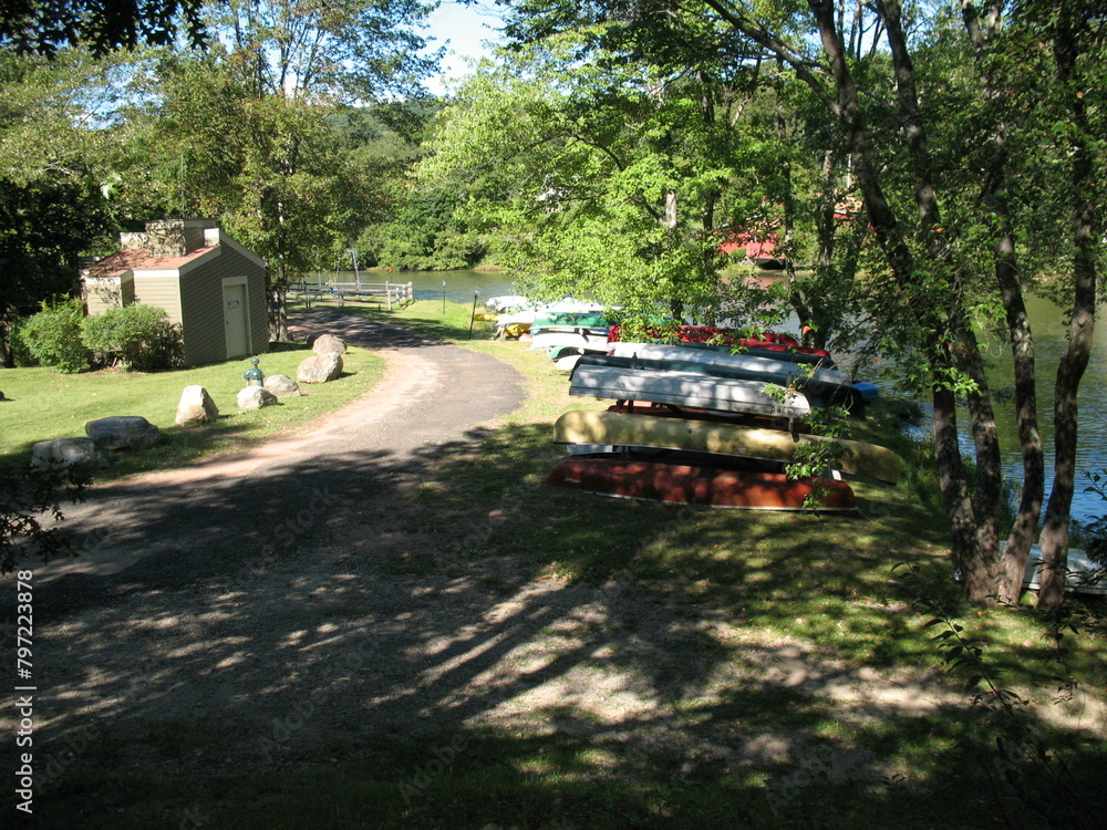 Canoes stored on a path leading to a lake Canoes stored on a path leading to a lake