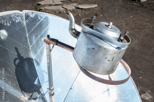 A kettle boiling on a solar cooker. This tool is uses the energy of the sun to cook or boiling water, reducing deforestation in remote areas of Nepal.