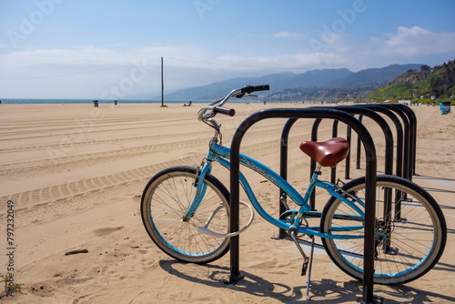 Beach cruiser bicycle parked on the beach off the marvin braude bike path in santa monica California.