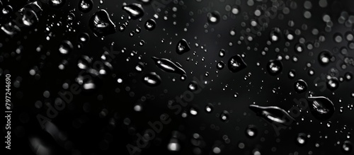 Abstract raindrops on black background photo