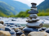 Zen stones stacked by a tranquil river in a mountain valley