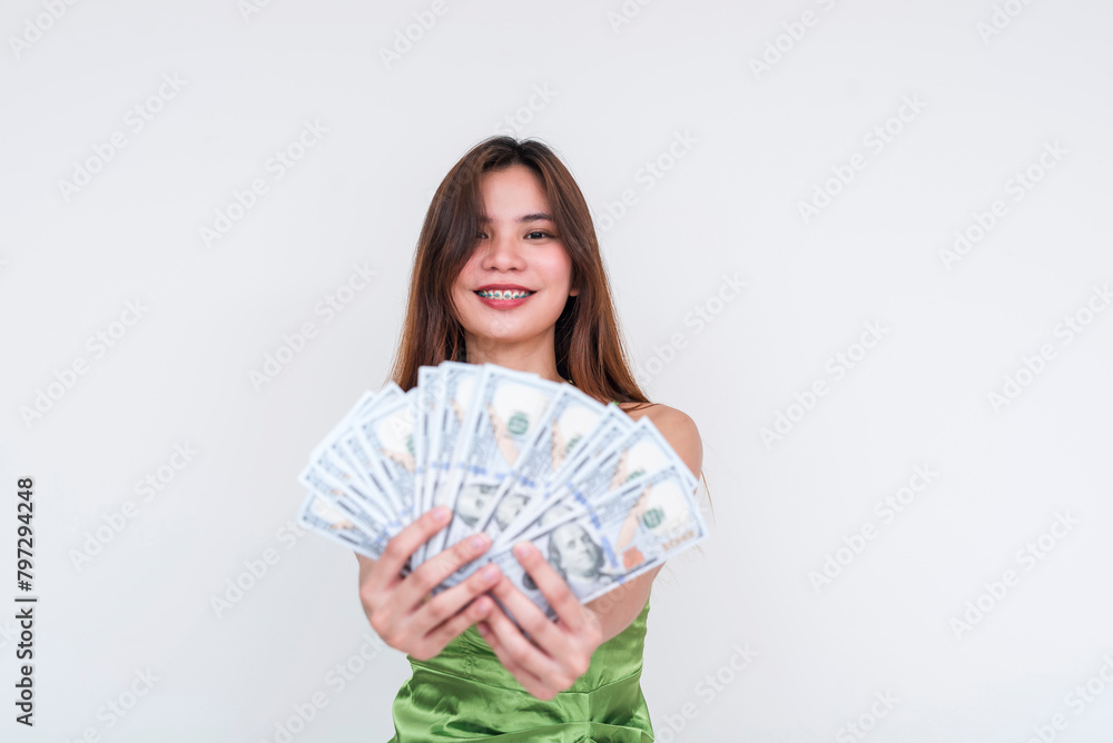 Young woman in green silk dress holding money, seductive lottery concept Young woman in green silk dress holding money, seductive lottery concept