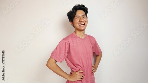 Handsome young Asian man is happy, cheerful and enthusiastic posing coolly with an isolated white background photo
