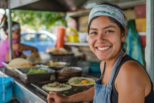 Fototapeta Naklejka Na Ścianę i Meble -  Mexican woman working at a street taco shop