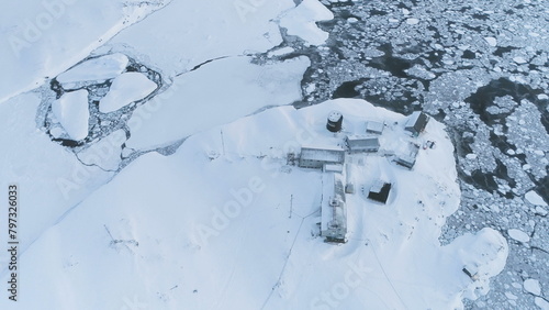 Vernadsky Station Among Antarctica Polar Landscape. Aerial Flight Over Antarctic Continent. Snow Covered Land Surrounded Ice Frozen Ocean. Settlement Among Wild Nature. Exotic Travel.