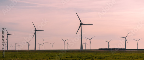 Panoramic views of many wind mills along the sea shore in the Netherlands.