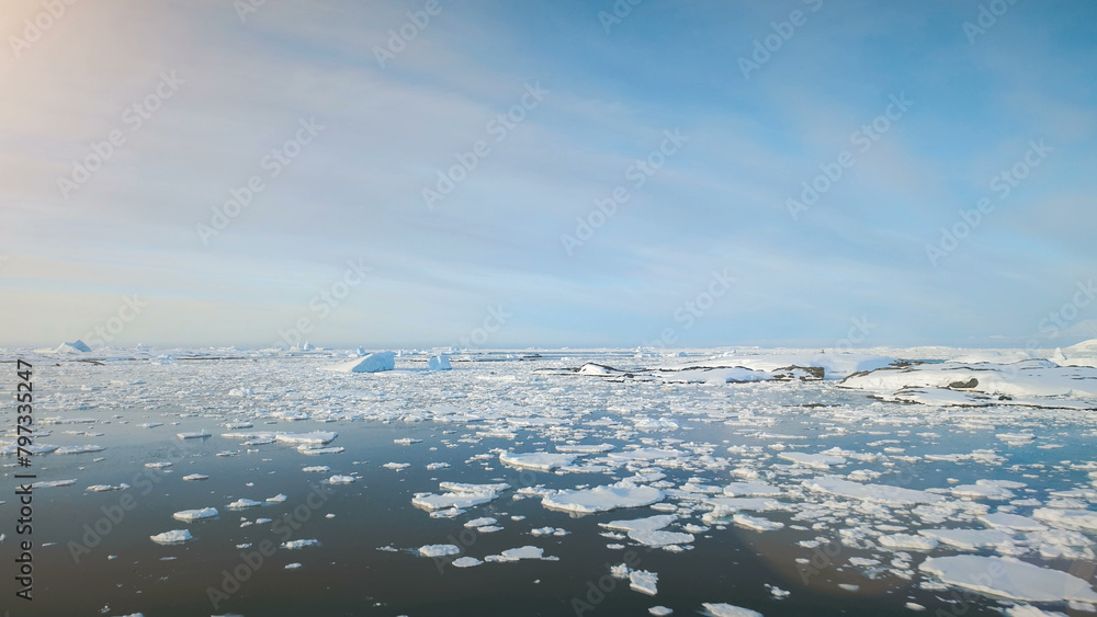 Aerial Flight Over Antarctica Ice Ocean Water. Drone Overview Of Snow, Ice Pieces Floating In Cold Polar Ocean. Winter Antarctic Landscape. Harsh Environment Of Antarctic Coast.