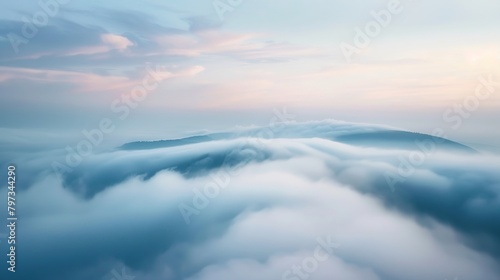 A mountaintop view where clouds and fog merge, blurring the horizon