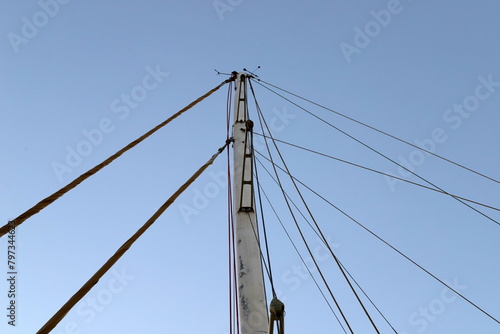Masts in the port against the blue sky.