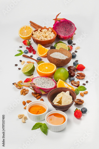 Assorted fresh fruits and nuts on a white background. Ingredients for a healthy dish