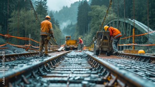 Three men are working on a railroad track