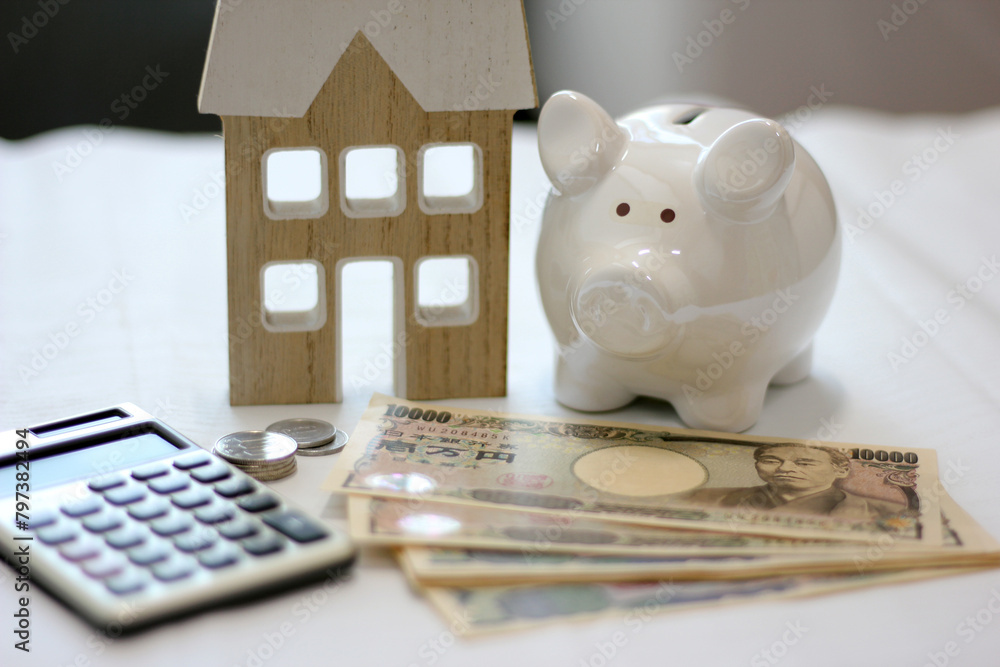 Fototapeta premium Real estate and finance concept with white piggy bank and Japanese money