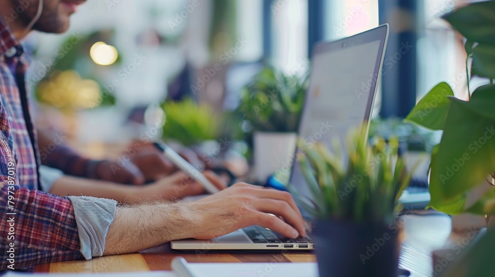 A snapshot of a modern collaborative workspace, with individuals focused on their laptops, immersed in productivity. A snapshot of a modern collaborative workspace, with individuals focused on their laptops, immersed in productivity.