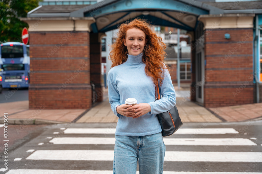 woman in casual clothes crossing road with coffee cup Lifestyle people