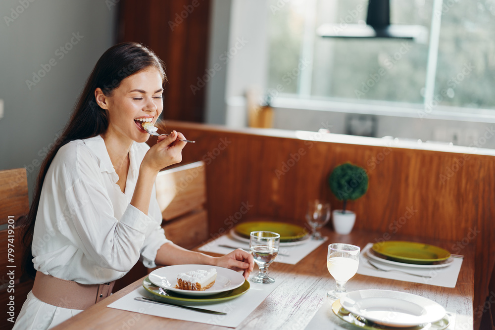 Smiling Woman Enjoying Romantic Dinner at Home Beautiful Brunette Sitting at Trendy Dining Table, Indulging in Homemade Cake and Wine Smiling Woman Enjoying Romantic Dinner at Home Beautiful Brunette Sitting at Trendy Dining Table, Indulging in Homemade Cake and Wine
