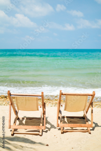 Seaside picnic chairs on an island with white beaches and bright blue waters for vacationers looking to relax.