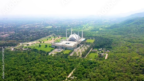  The capital city of Pakistan showing the landmark Shah Faisal Mosque and the lush green mountains of Margala Hills. Aerial shot of Islamabad. photo