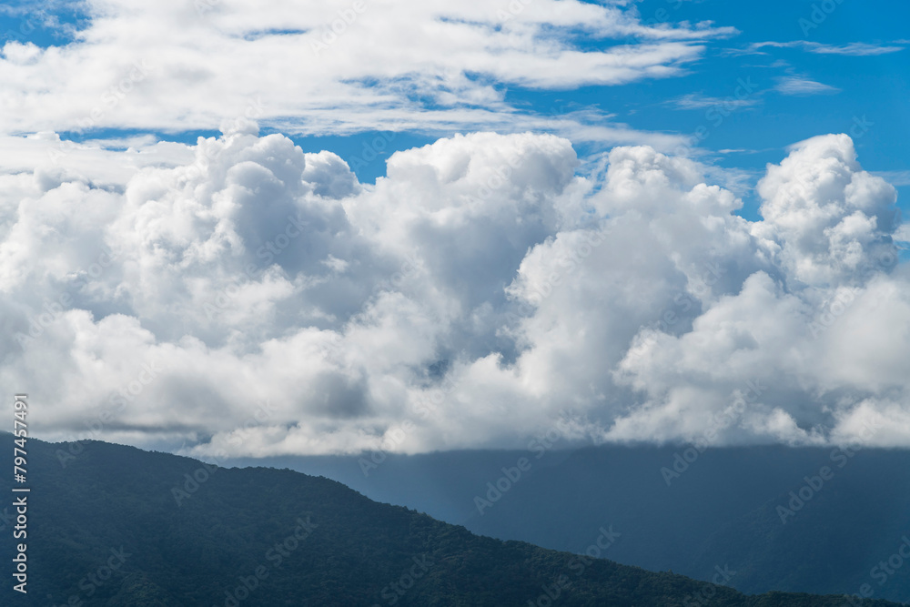 Rolling mountains with blue sky and clouds background. Rolling mountains with blue sky and clouds background.