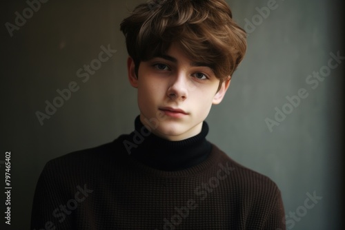 a young man with brown hair wearing a black turtleneck