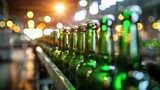 A vertical shot of green beer bottles lined up on a factory conveyor with a soft focus on the bright background lights
