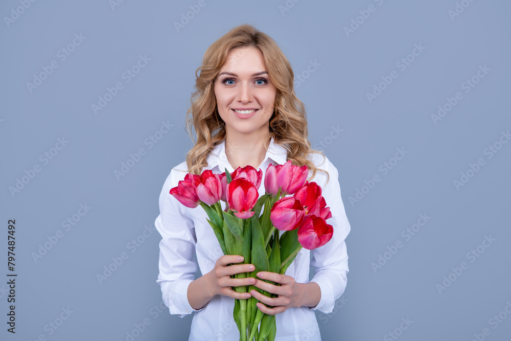 cheerful girl with spring tulip flowers on grey background cheerful girl with spring tulip flowers on grey background