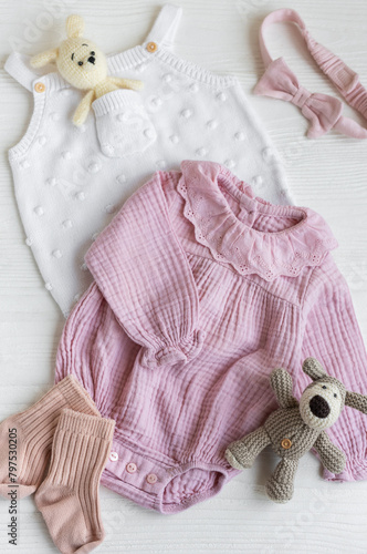 Set of pink clothes and accessories for newborn baby.