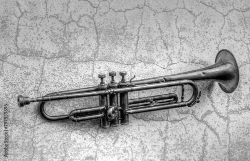 Canvas Print an antique Jazz trumpet on an old wall in black and white