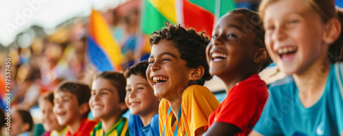 Group of happy children watching together a sports event in the stadium 