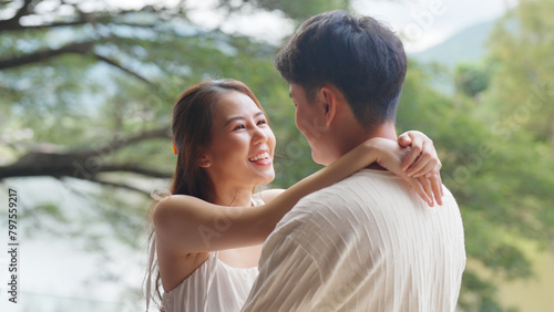Sweet lovers arm around shoulder hug neck face to face talking at outdoor nature. Trust true love smile happy asia people in casual bride groom white dress begin family life just married young couples