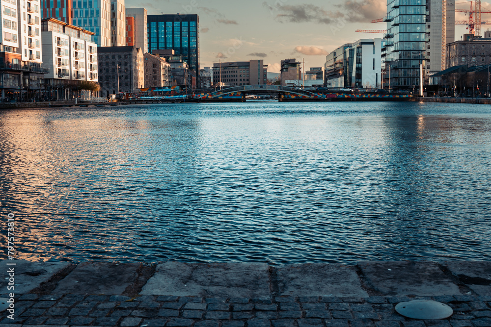 Fototapeta premium View Of Grand Canal Dock From Grand Canal Square In Dublin Docklands. Symbol of urban regeneration and technological advancement. With modern architecture and corporate headquarters, including those