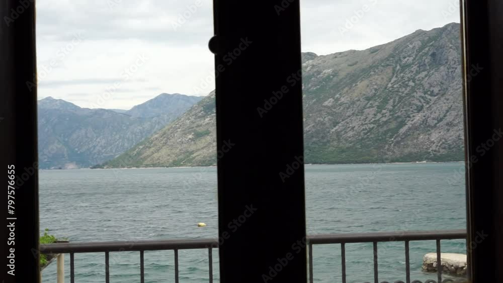 view from the window to the sea and mountains view from the window to the sea and mountains