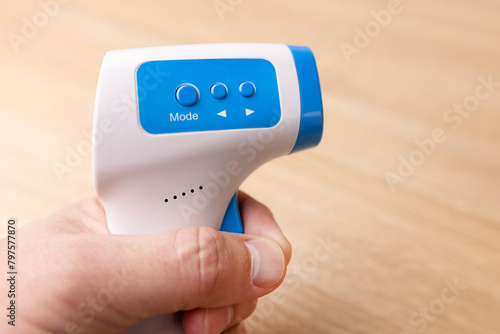 Remote thermometer with settings for measuring human body temperature. photo