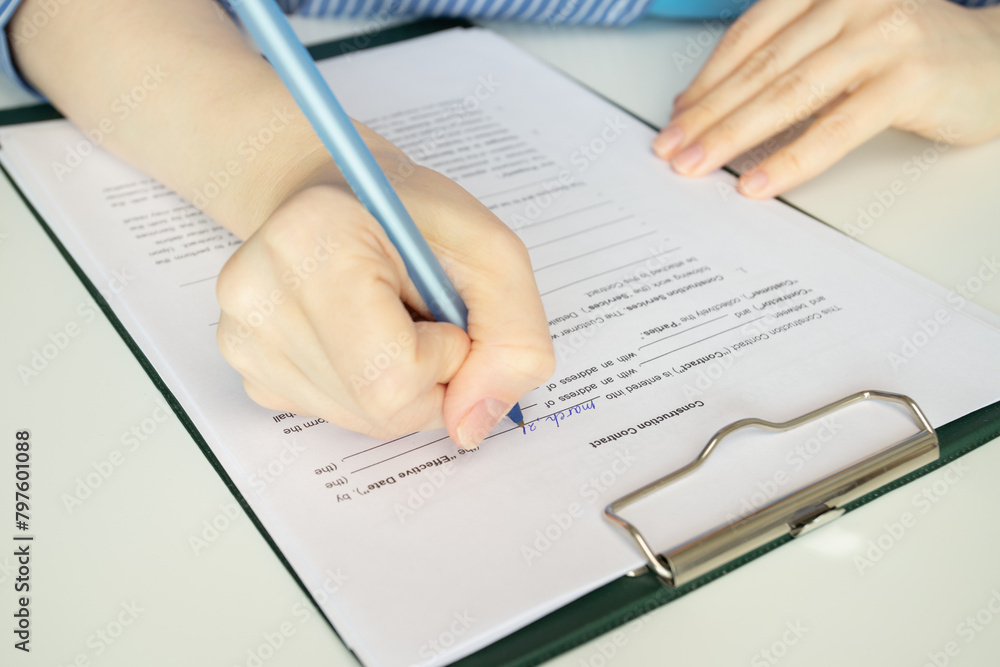 Construction contract, hand fills out a document, architect finalizing project details, contractor reviewing agreement terms Construction contract, hand fills out a document, architect finalizing project details, contractor reviewing agreement terms