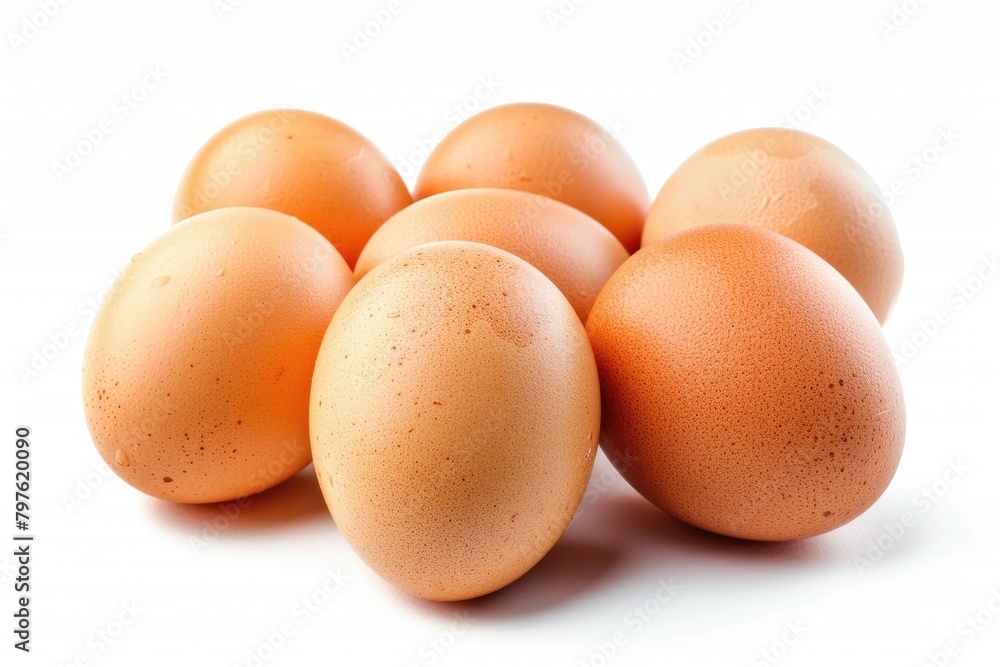A cluster of fresh brown chicken eggs with a natural speckled pattern isolated on a white background. A cluster of fresh brown chicken eggs with a natural speckled pattern isolated on a white background.