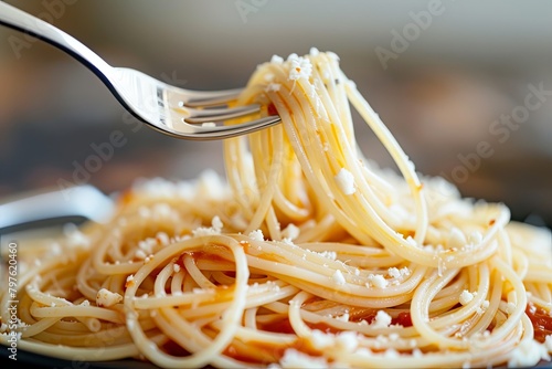 Suspended Spaghetti Delight: Fork in Motion with Drizzled Sauce and Cheese