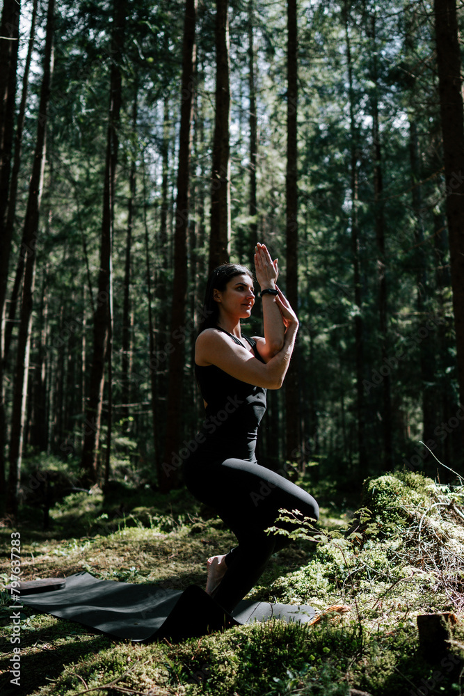 A young woman does yoga and meditates in the forest. Yoga and meditation concept. Yoga asanas. A young woman does yoga and meditates in the forest. Yoga and meditation concept. Yoga asanas.