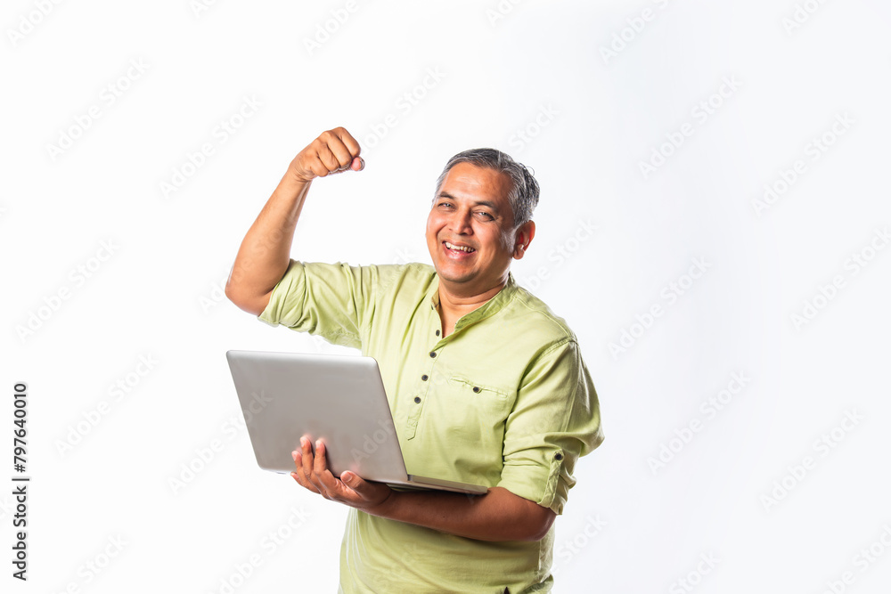Indian asian mid age man using laptop against white background Indian asian mid age man using laptop against white background
