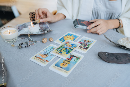 A woman is making tarot layout on the table