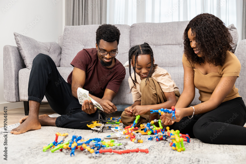 Fototapeta premium Family Bonding Over Board Games: Happy African Family Playing Together, Parents And Child Indoor Activity