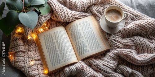A cup of coffee, a book and a cozy blanket. What else do you need for a perfect evening? photo