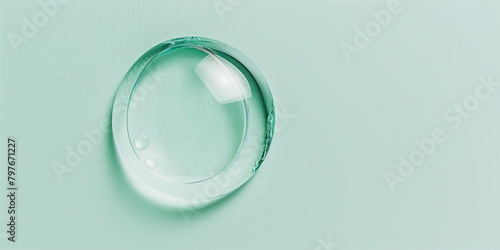 Large, round drop of liquid on a green background
