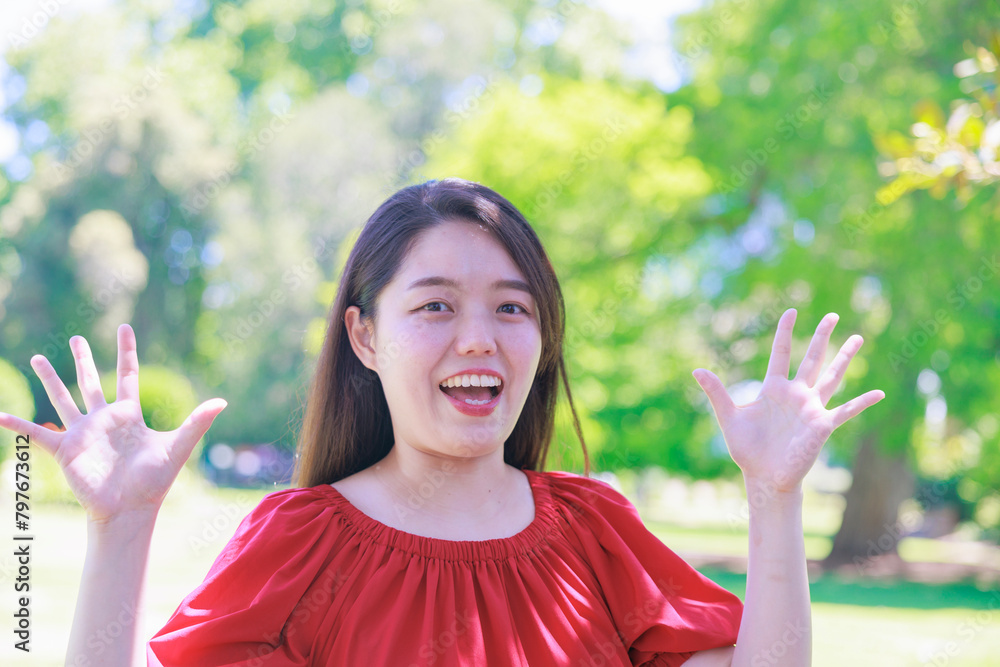 手を挙げて驚くふりをする日本人女性 Stock Photo | Adobe Stock