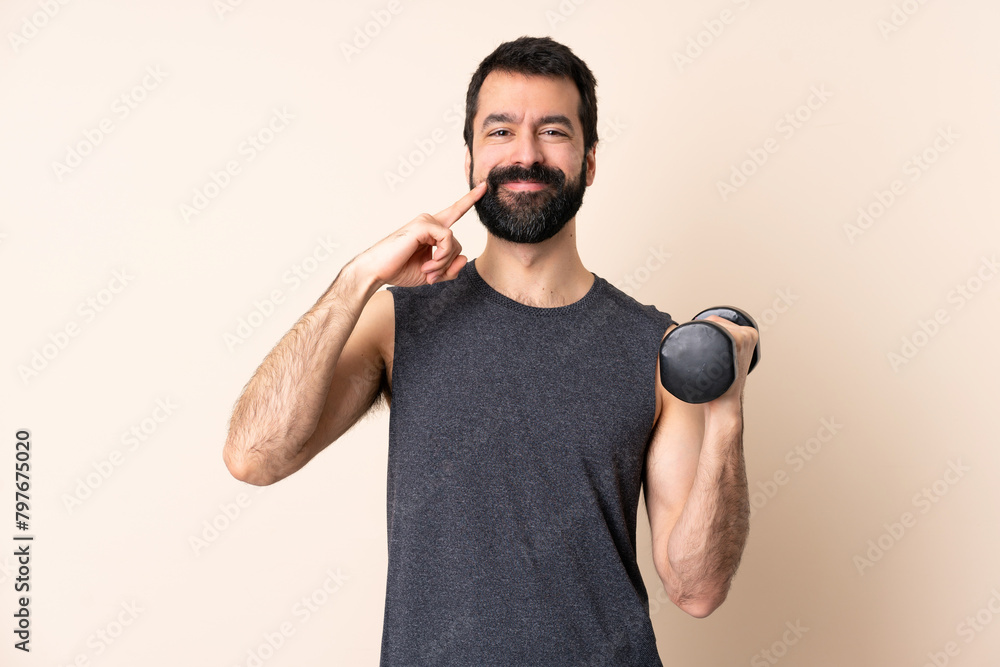 Caucasian sport man with beard making weightlifting over isolated background smiling with a happy and pleasant expression Caucasian sport man with beard making weightlifting over isolated background smiling with a happy and pleasant expression