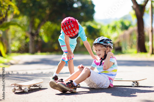 Kids with skate board. Skateboard fall and injury. photo