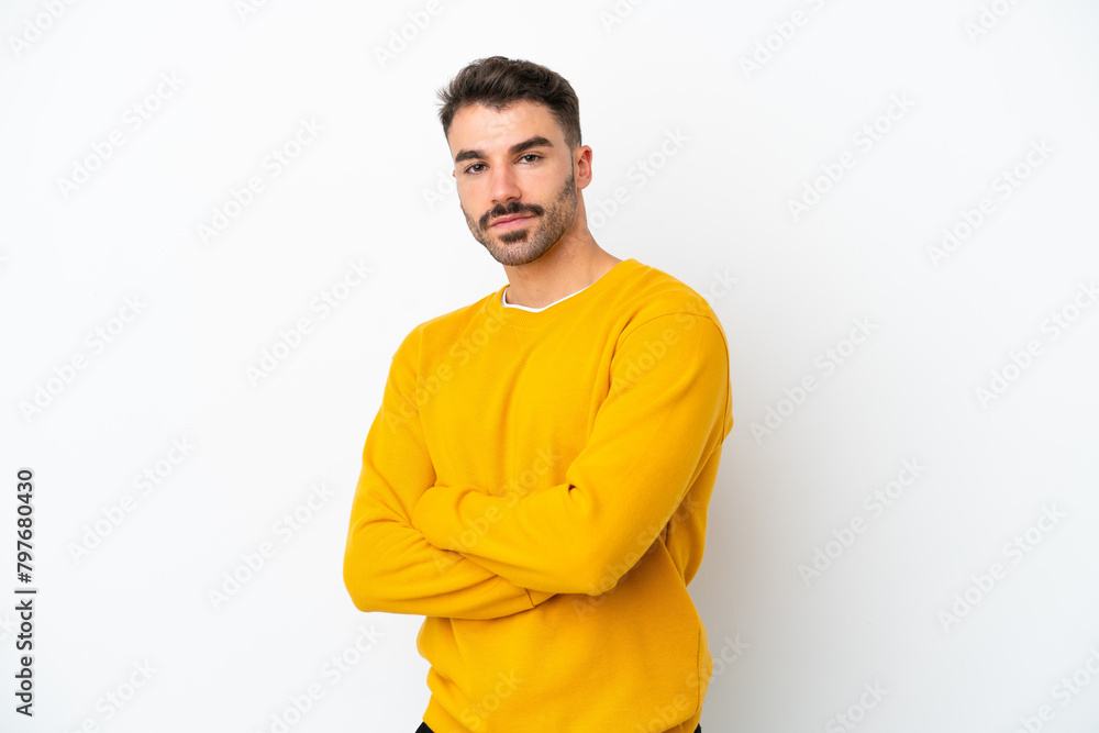 Young caucasian man isolated on white background with arms crossed and looking forward Young caucasian man isolated on white background with arms crossed and looking forward