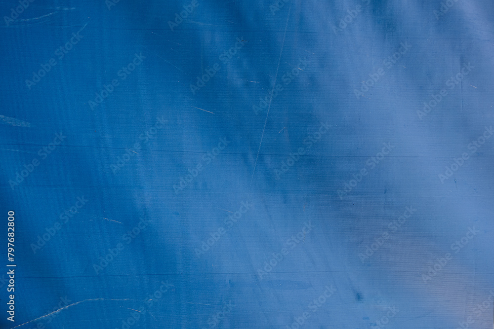 Naklejka premium abstract background of old dirty blue tarpaulin close up