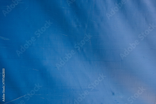 abstract background of old dirty blue tarpaulin close up © Mariia