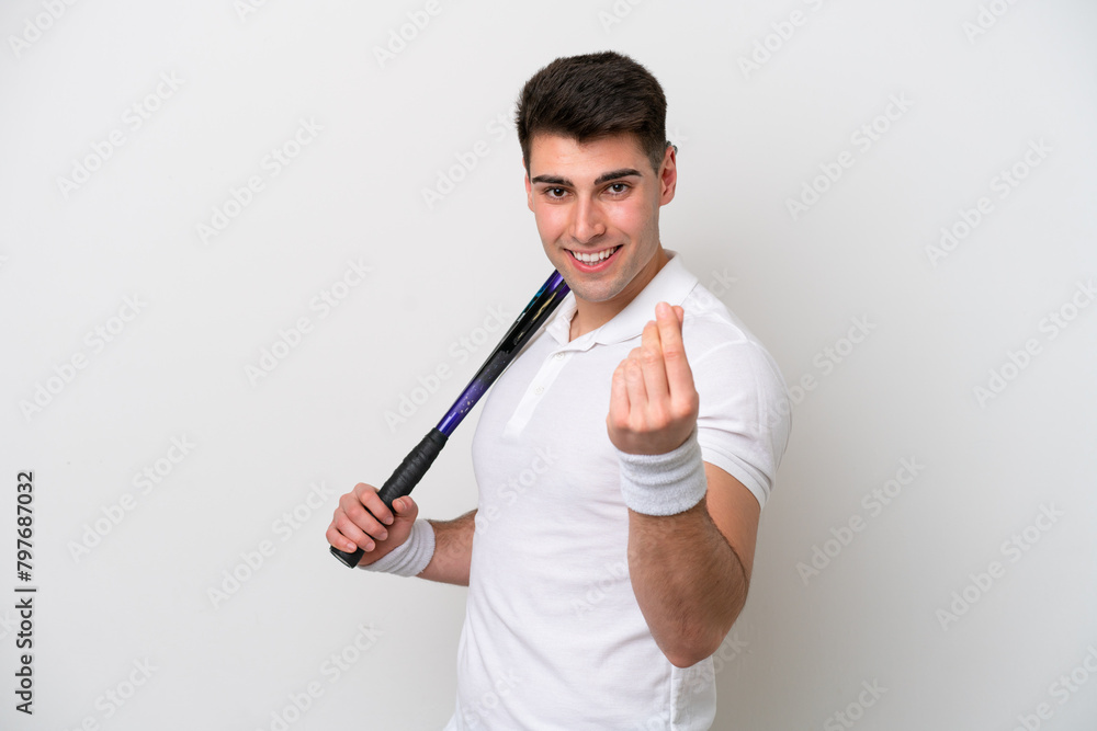 young tennis player man isolated on white background making money gesture young tennis player man isolated on white background making money gesture